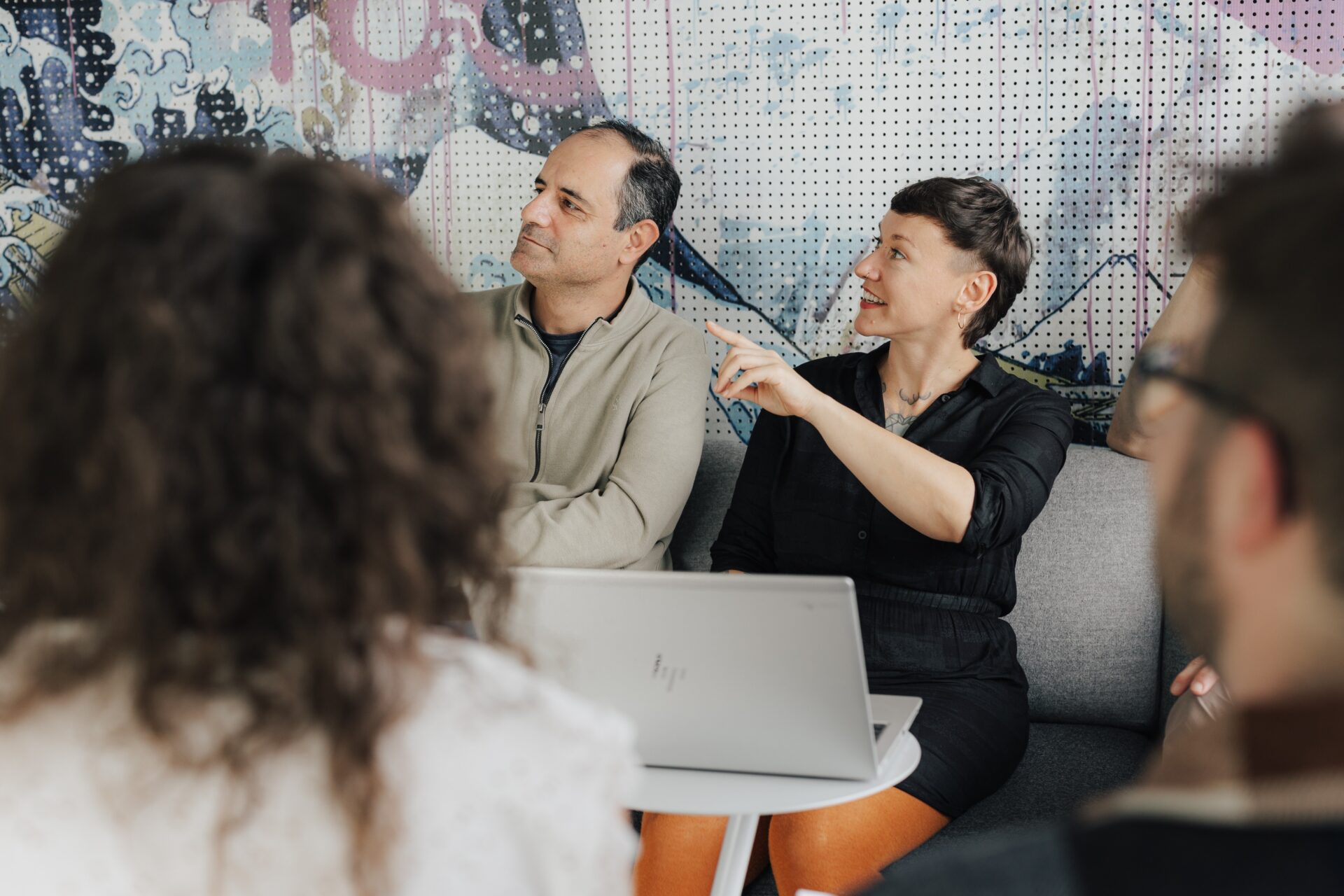 Two COPA-DATA employees sit next to each other and look to the left.