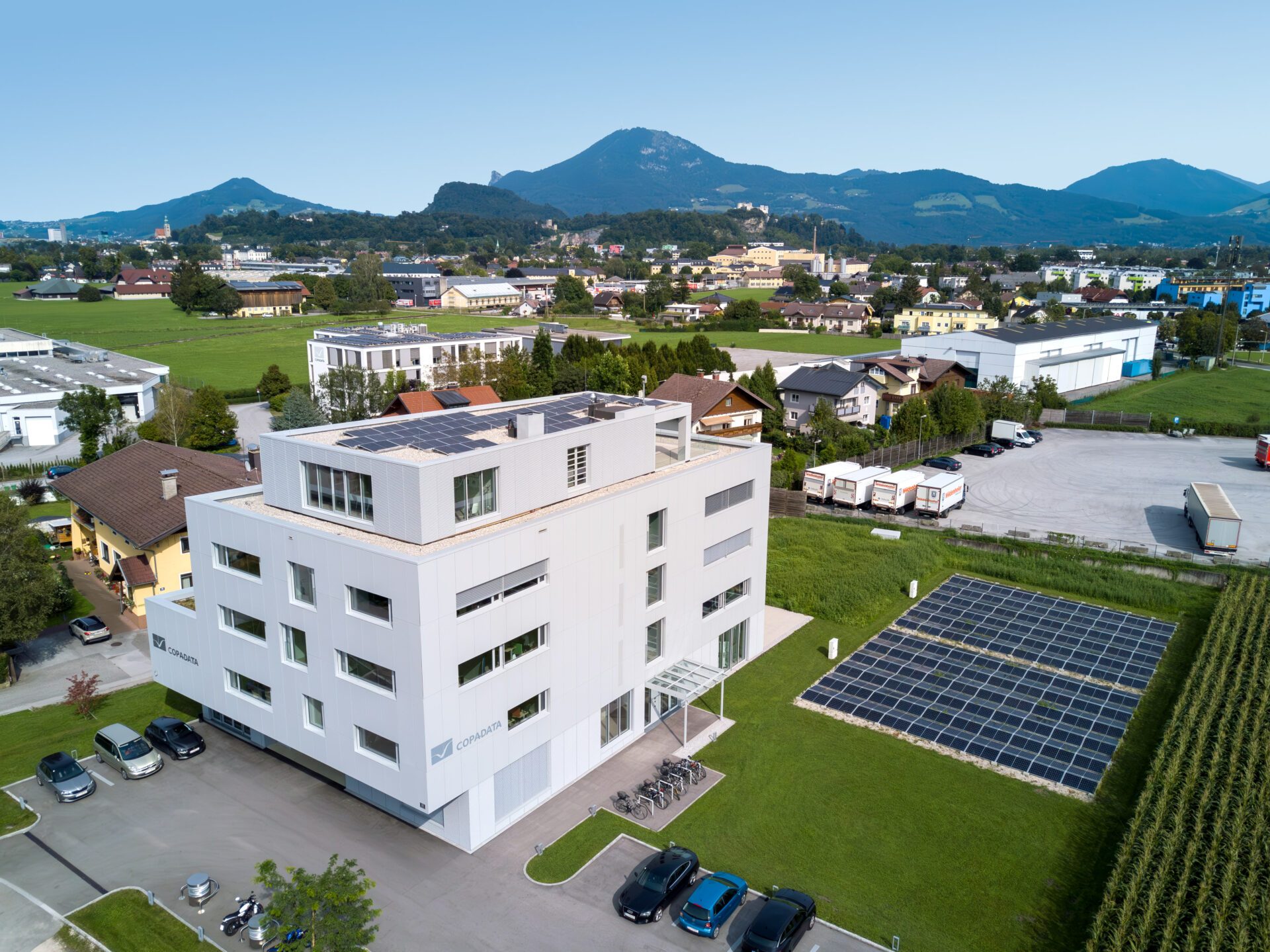 Aerial photo of the COPA-DATA headquarters with mountains in the background.